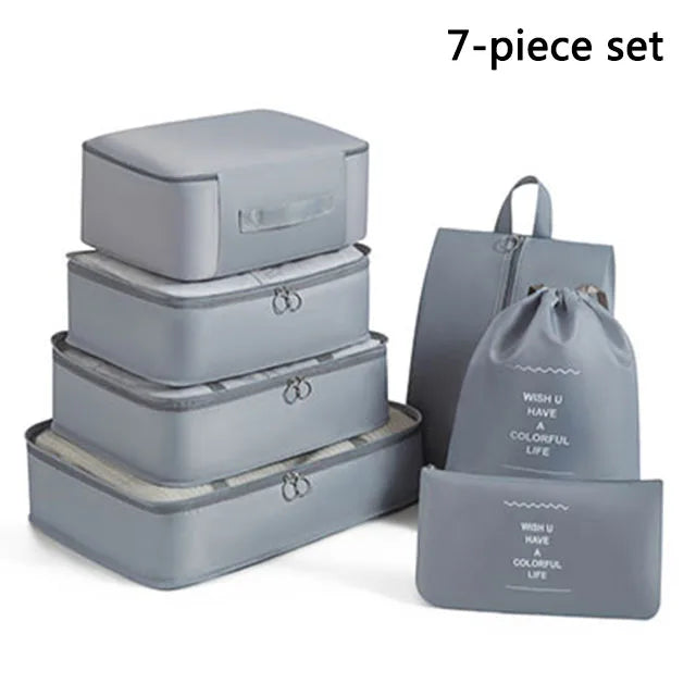 Set of gray travel packing cubes and a drawstring bag with text on a white background
