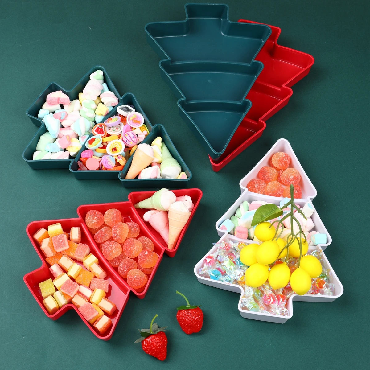 Colorful candy arrangements in Christmas tree-shaped trays on a green background