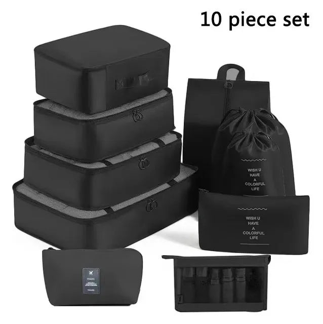 Set of black travel packing cubes with various sizes and a drawstring bag on a white background.