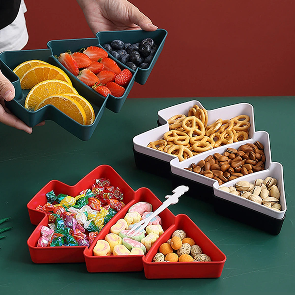 Set of colorful snack trays with various food items on a green surface.