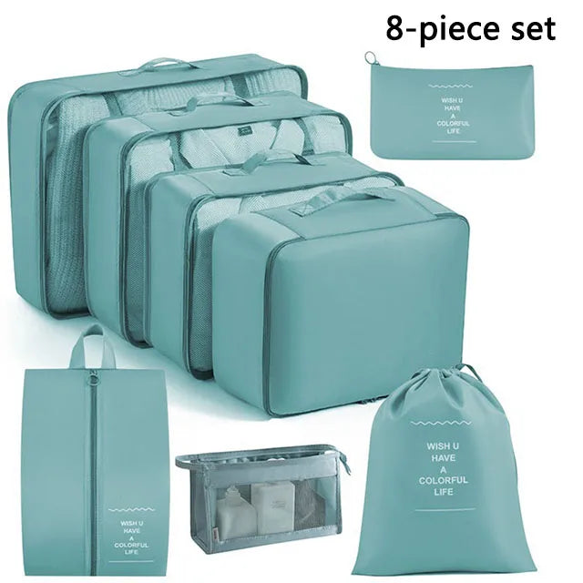 Set of eight teal packing cubes and bags on a white background